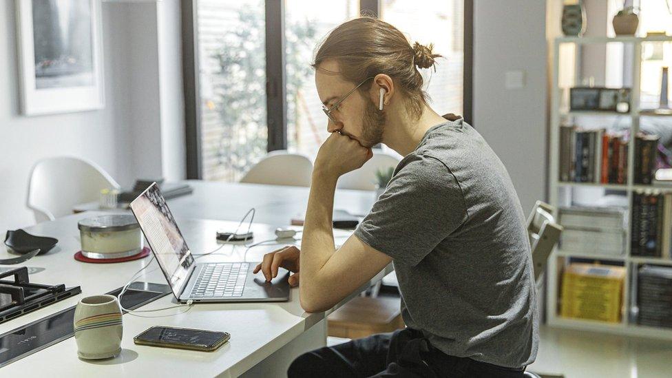 Man working from home on a laptop.