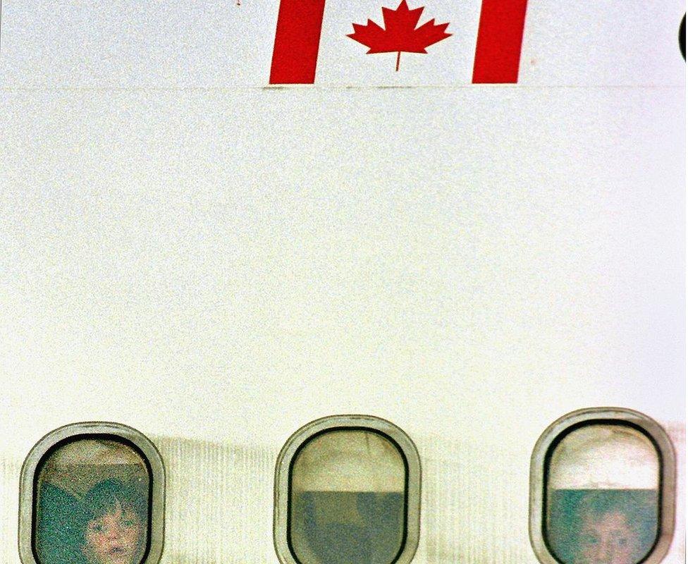 Two boys fleeing from Kosovo aboard a plane to Canada 1999