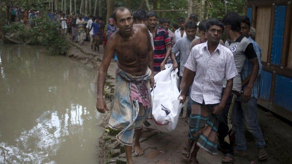 Villagers carry a body recovered from the ferry sinking in Barisal, Bangladesh, on 21 September 2016