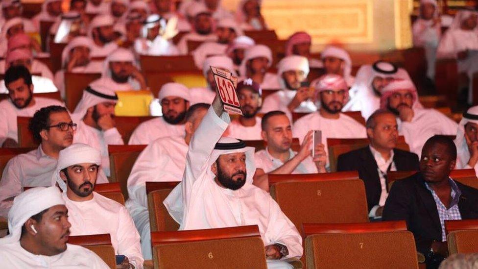 A man bids at the car licence plate auction in Abu Dhabi