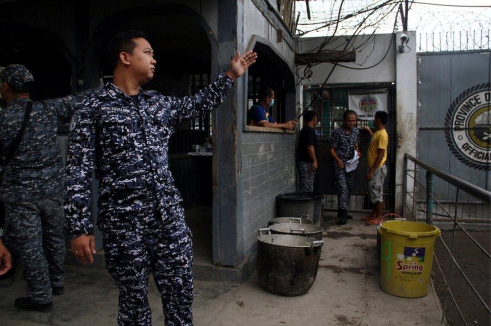 A prison personnel gestures during an interview following the escape of more than 150 inmates after gunmen stormed a prison in North Cotabato province, southern Philippines.