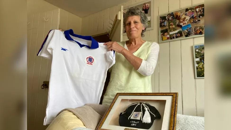 Eileen Foreman holding her Lioness shirt