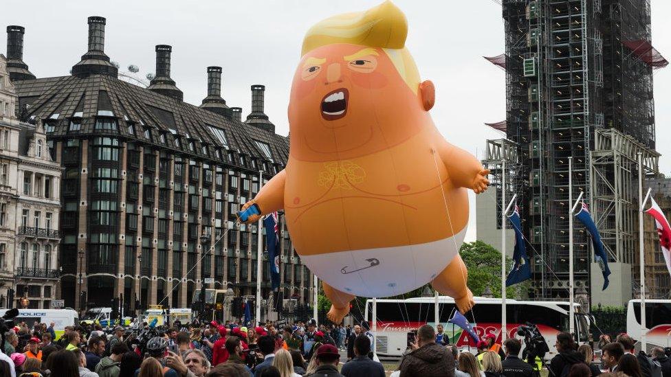 The Trump baby blimp surrounded by protesters in Parliament Square