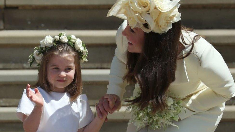 Princess Charlotte waves to the crowds, as she holds her mother, the Duchess of Cambridge's, hand