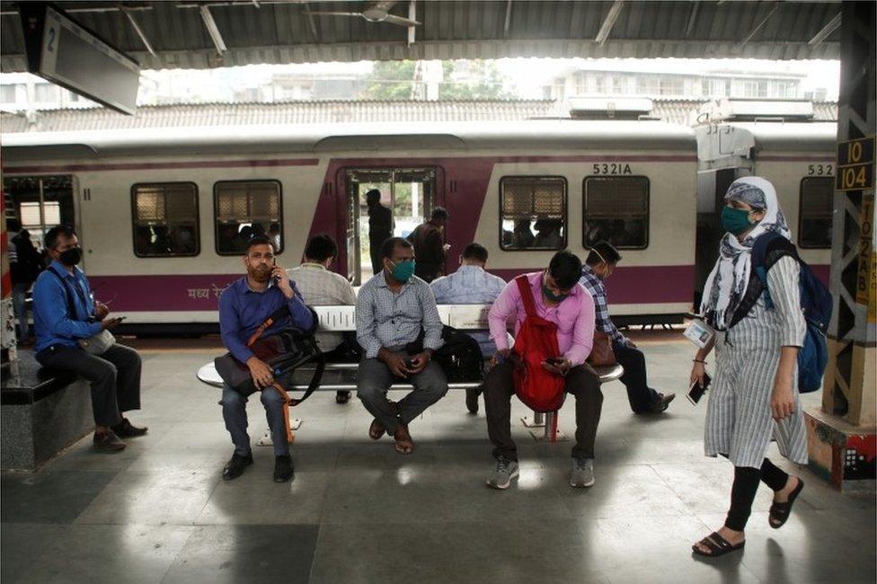 Commuters wait on a railway platform after trains were stalled during a power outage in Mumbai, India, October 12, 2020.