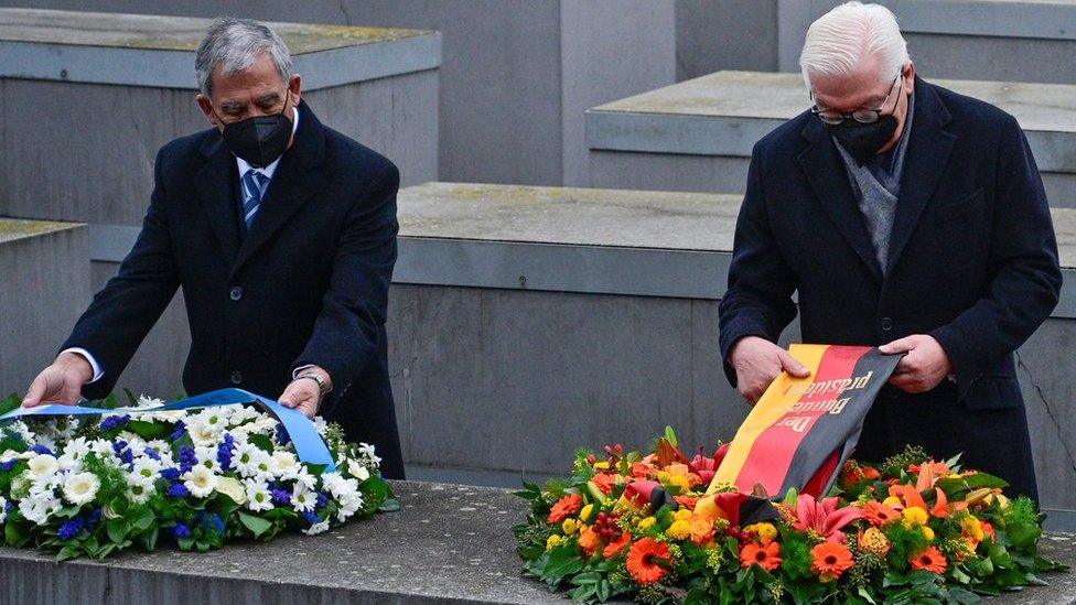 German President Frank-Walter Steinmeier and the Speaker of Israel's Knesset parliament Mickey Levy arrange wreaths at Berlin's Holocaust memorial on 27 January 2022