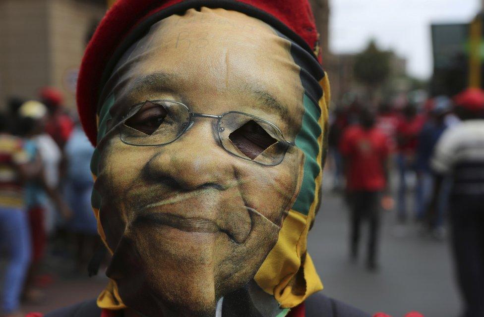 A protester wears a mask depicting South African president Jacob Zuma during a protest march in Pretoria, South Africa, Wednesday, Nov. 2, 2016