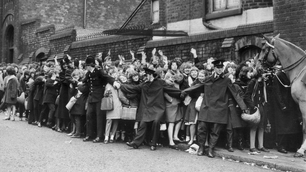 A queue of fans wait to see The Beatles