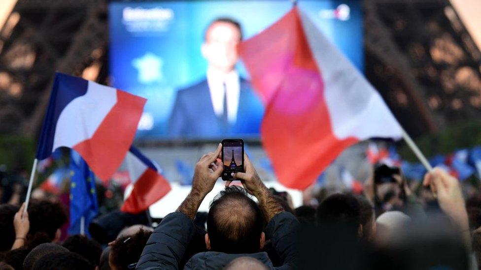 Supporters react after the victory of Macron