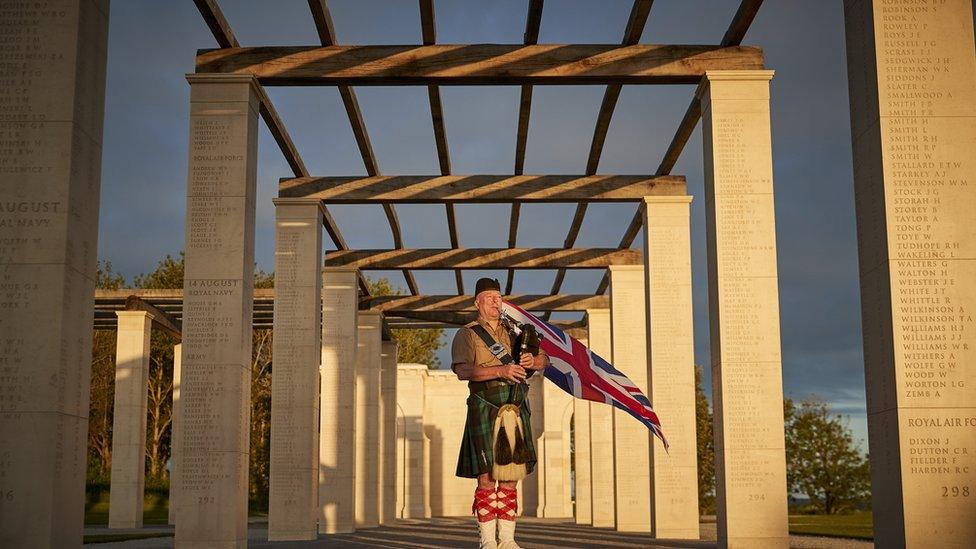 British Piper Steve Black plays at sunrise to mark the 77th anniversary of D-Day at the British Normandy Memorial on Sunday