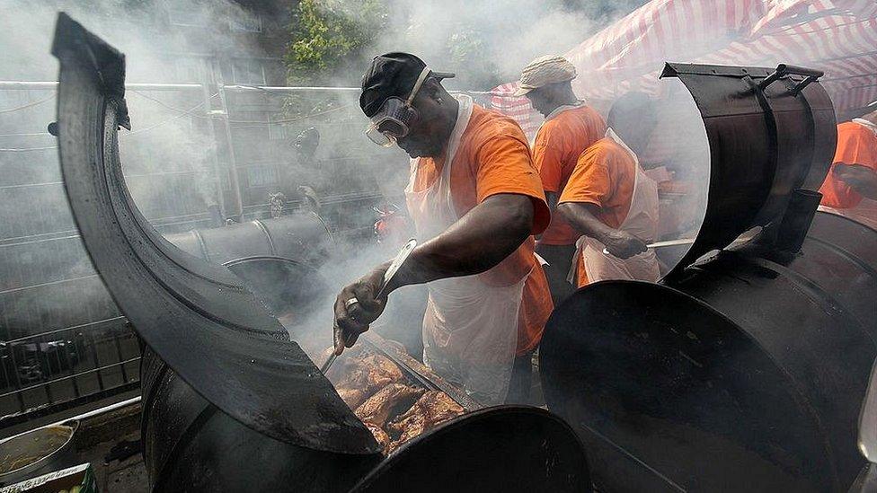 Street food chefs cook jerk chicken at the Notting Hill Carnival 2011