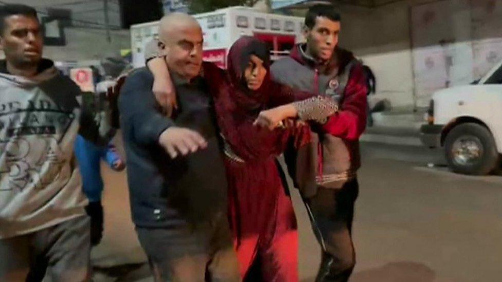 Injured woman being walked to hospital in Rafah