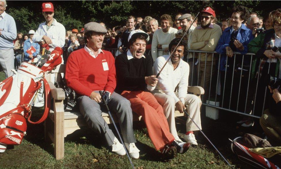 1981: Terry Wogan, with the comedian, Jimmy Tarbuck and the American pop singer, Johnny Mathis, during the Bob Hope British Classic golf tournament at Moor Park golf course