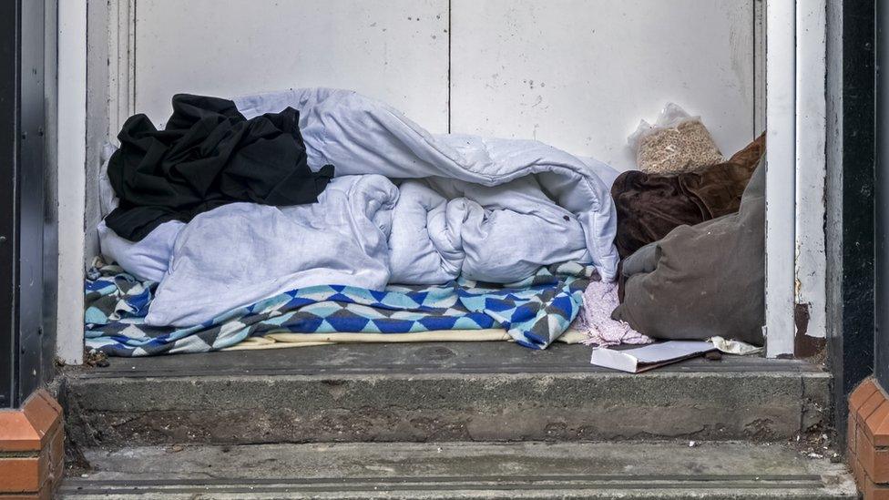 A makeshift bed in a doorway