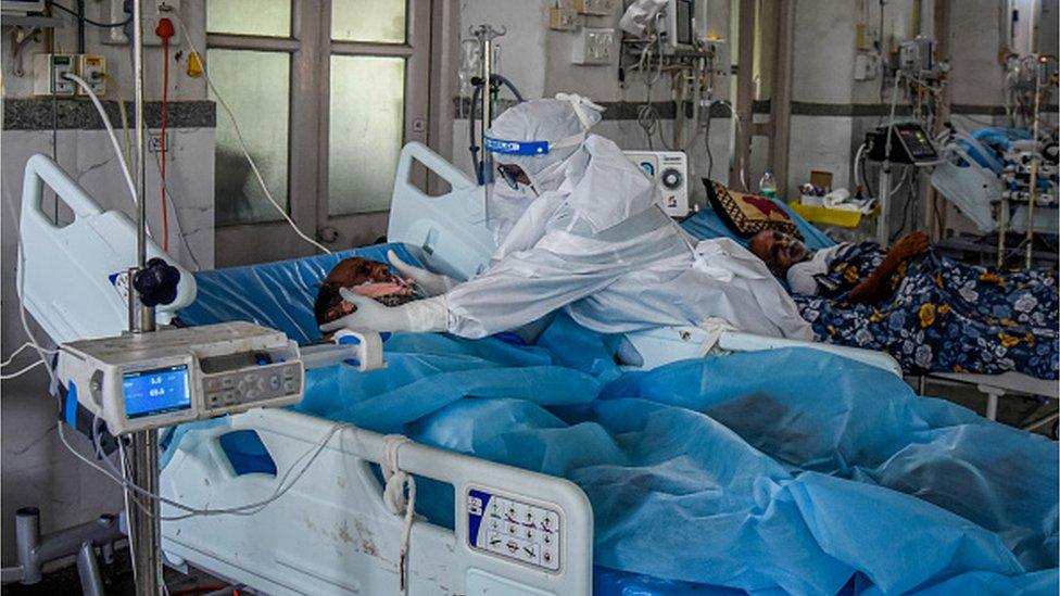 Healthcare worker Shama Shaikh, 53, cares for a patient who has Covid-19 in an ICU ward at the government-run St. George hospital on May 27, 2021 in Mumbai, India.