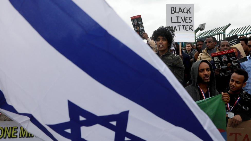 African asylum seekers take part in a protest against Israel's deportation policy in front of the Israeli Parliament in Jerusalem on January 26, 2017