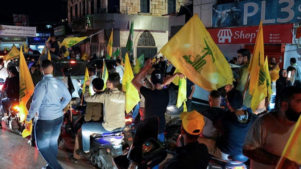 Hezbollah supporters wave the group's flags at a post-election rally in Nabatiyeh, southern Lebanon (15 May 2022)