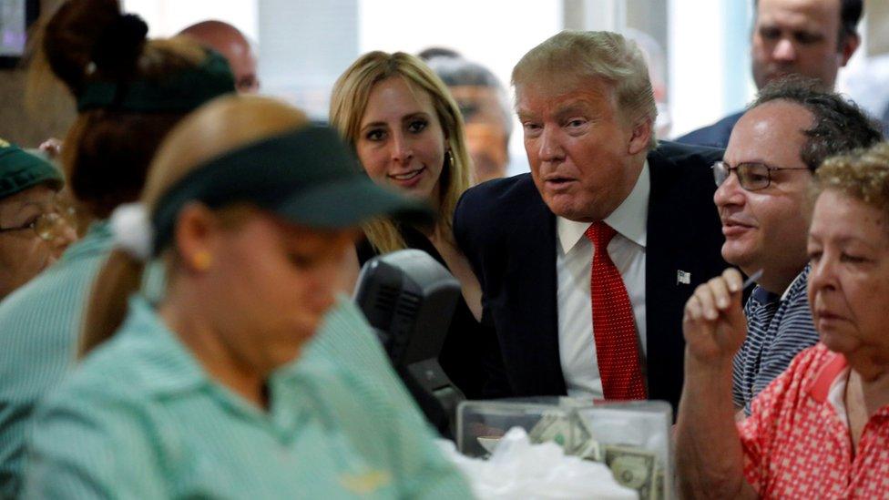 U.S. Republican presidential nominee Donald Trump greets employees at the Versailles Bakery in Miami, Florida, U.S. September 27, 2016