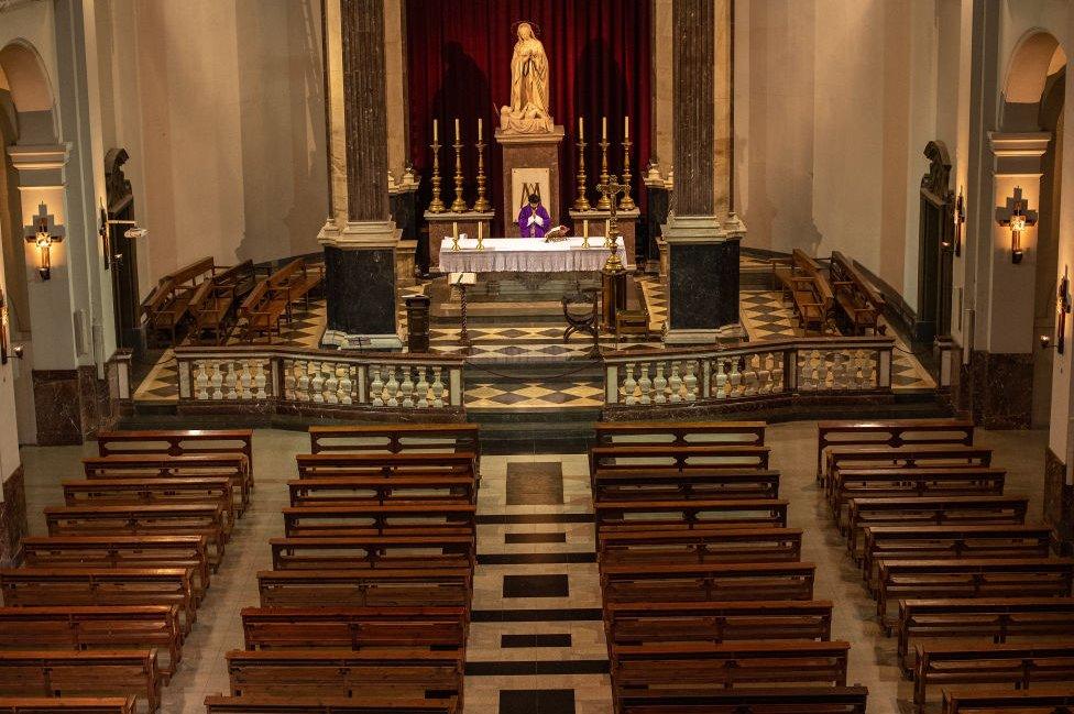 Priest Carlos Enrique Leal holds Mass