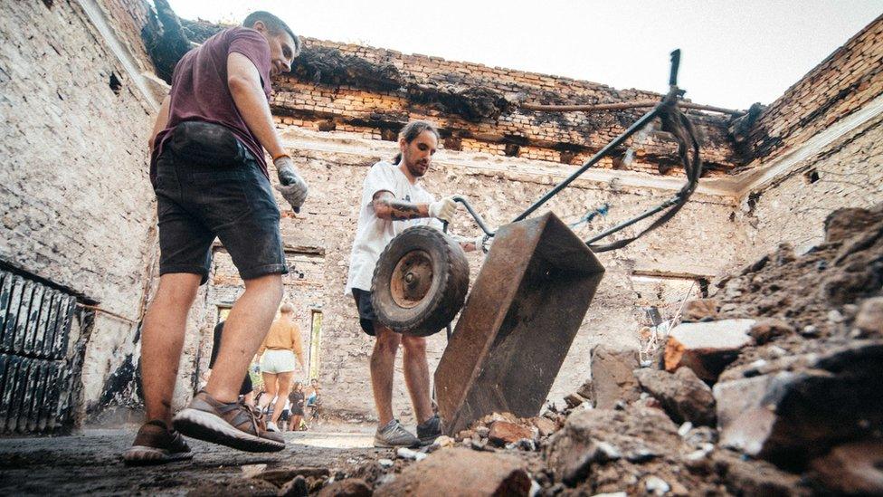 Rubble and dust being cleared