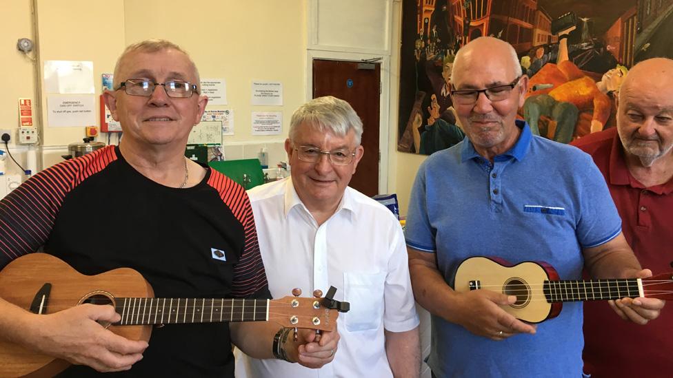 John with members of a ukulele band at his project in Maesteg