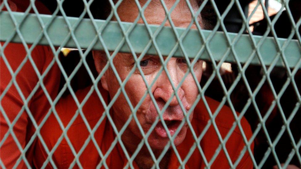 James Ricketson behind the bars of a police vehicle in August