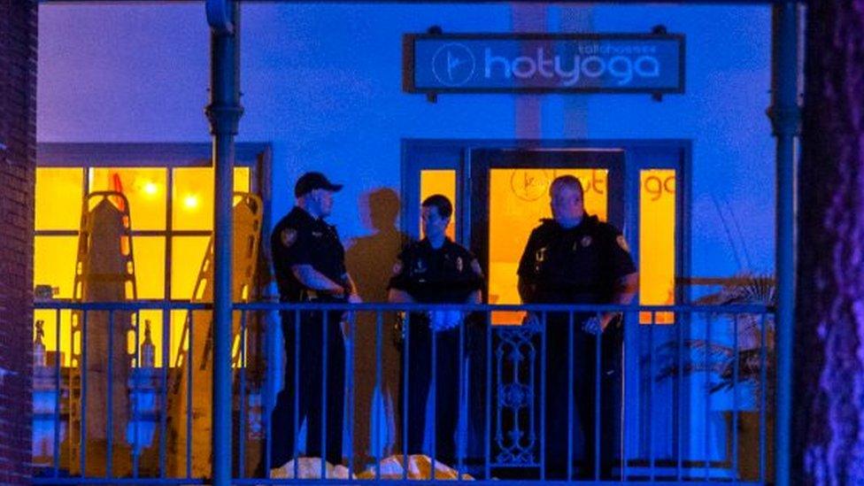 Tallahassee Police officers are stationed outside the HotYoga Studio