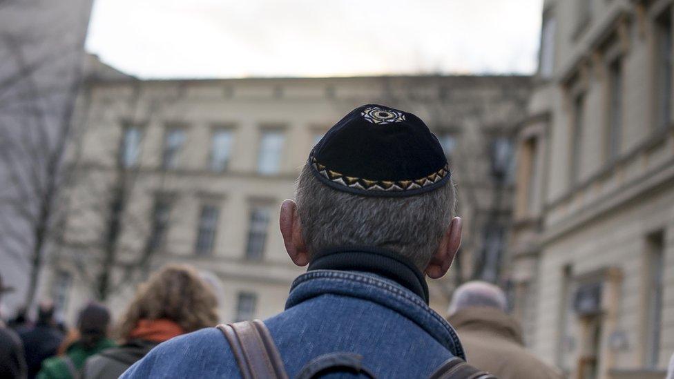 A man wears a kippa as he takes part in a silent march to commemorate the 75th anniversary of the Kristallnacht pogroms on November 9, 2013 in Berlin, Germany