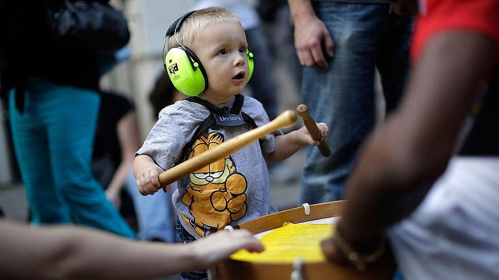 Child wearing ear defenders at Notting Hill Carnival