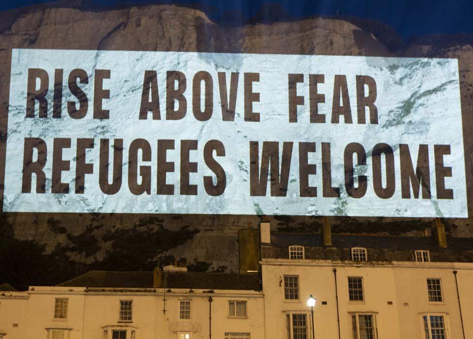 Sign beamed on to cliffs