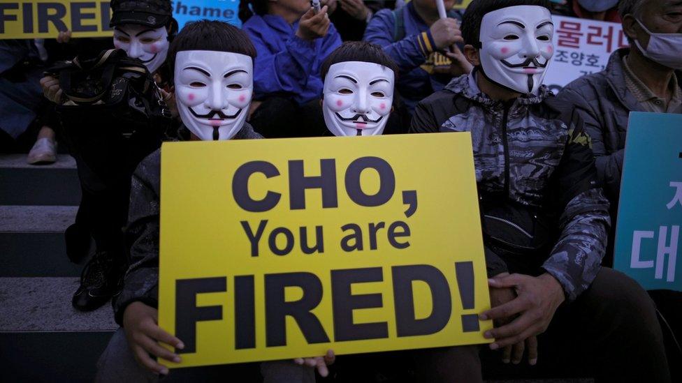 Masked Korean Air staff protest against abuses of power by the company's controlling family in central Seoul, South Korea, 4 May 2018