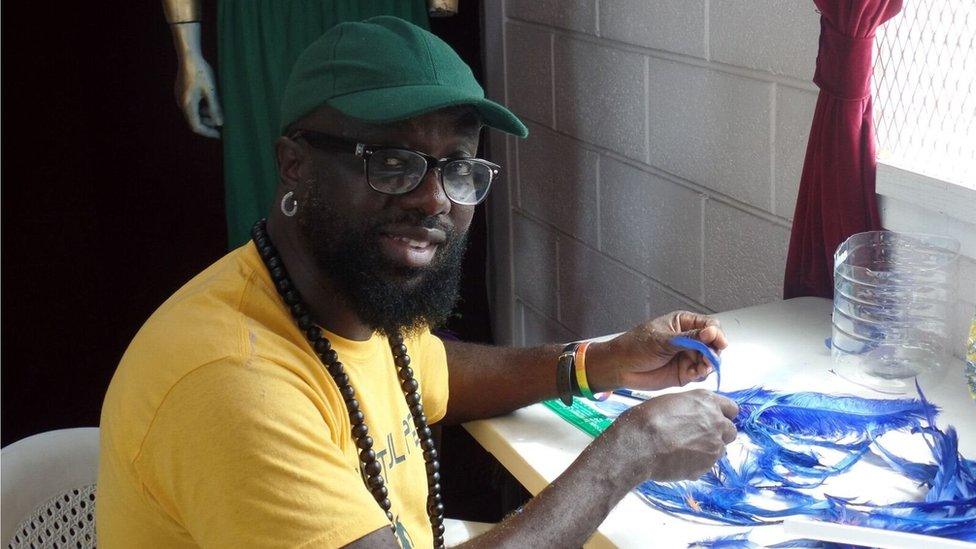 Calvin Southwell handles some feathers in the workshop