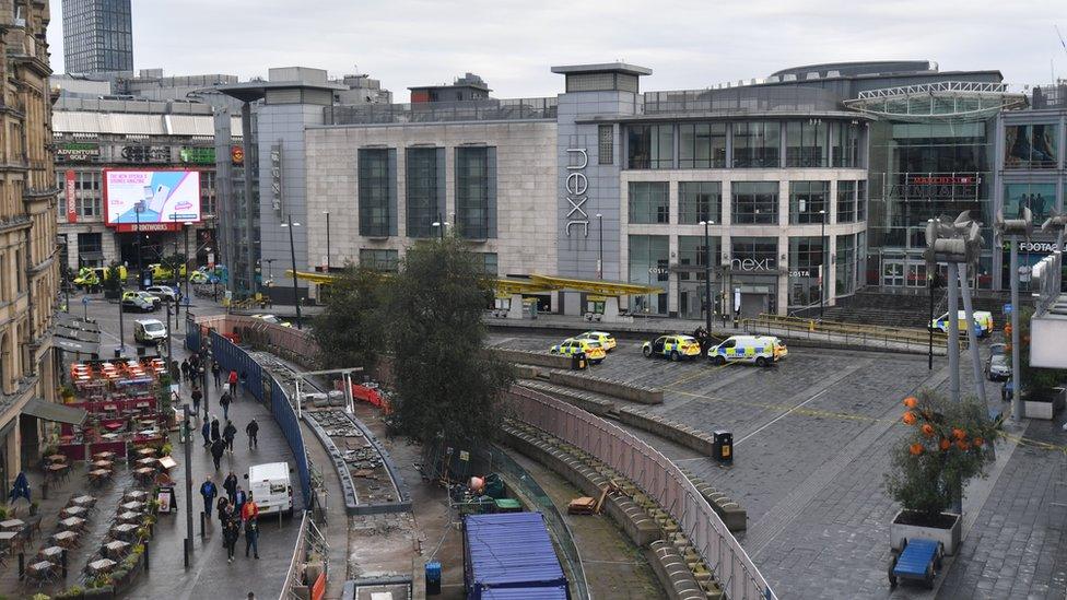 View of the Arndale Centre with police cars from a distance