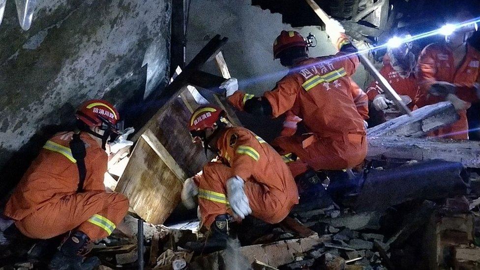 Rescuers search for survivors in the rubble of a building in Yibin, in China's southwest Sichuan province early on June 18, 2019