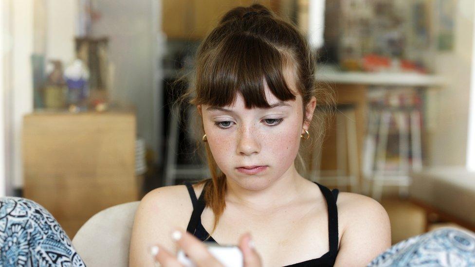 Teenage girl looking at her phone