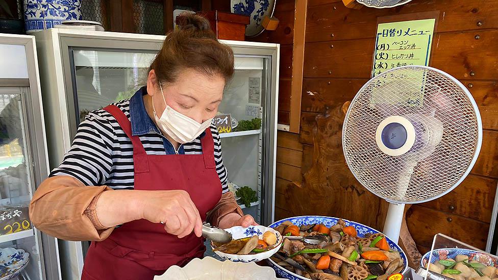 Japanese cafe owner serves lunch.