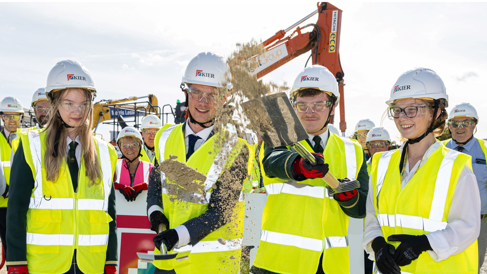 King Edmund School students putting spades in the ground