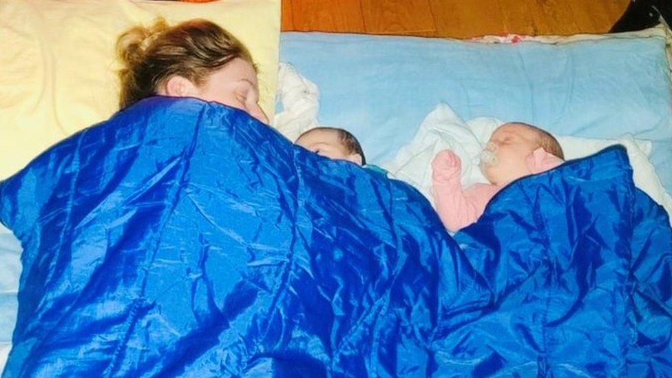 Siobhan Bradley and twins in front of fire