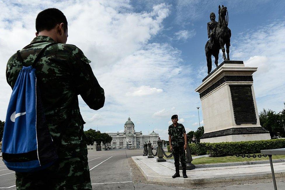 Soldiers take pictures in front of King Rama V statue and Ananta Samakhom Throne Hall the day after the controversial constitutional referendum in Bangkok on 8 August 2016.