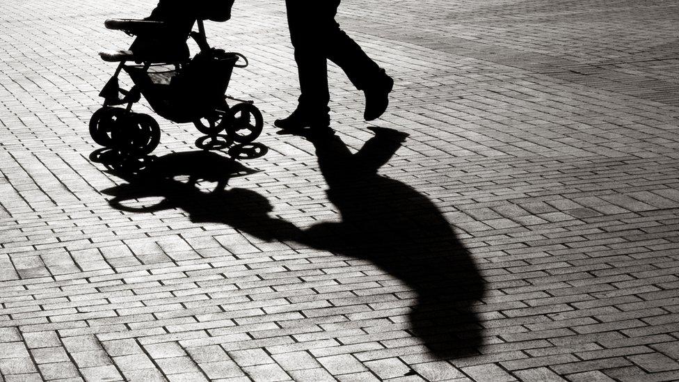 Parent pushing pram