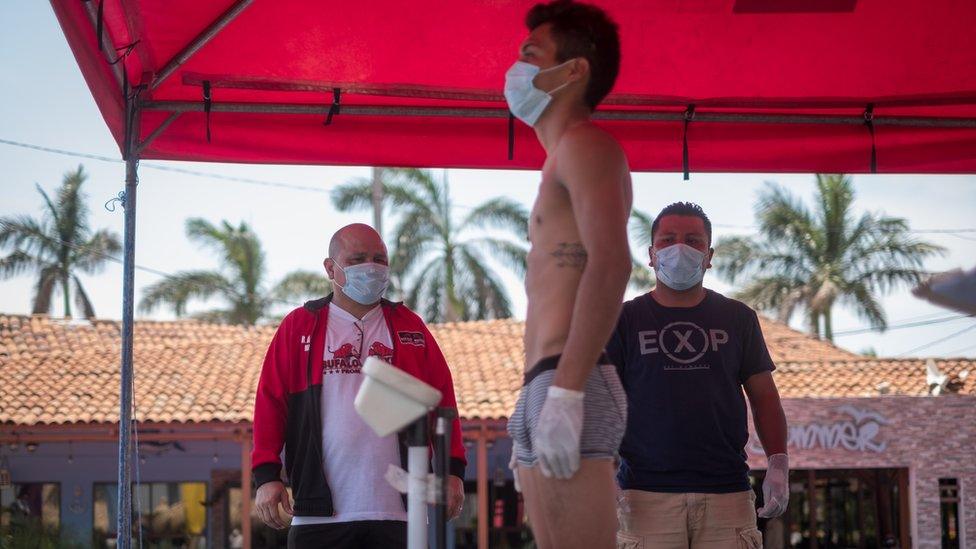 Nicaraguan boxing promoter Rosendo Álvarez watched the weigh-in while wearing a mask