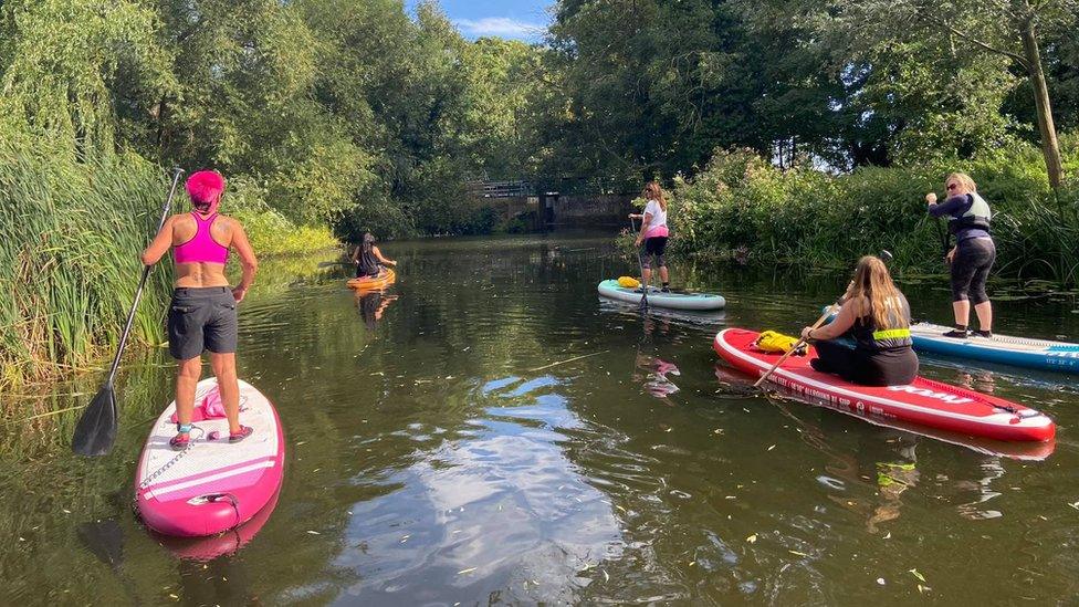 Melanie Miller with friends she has made through paddleboarding