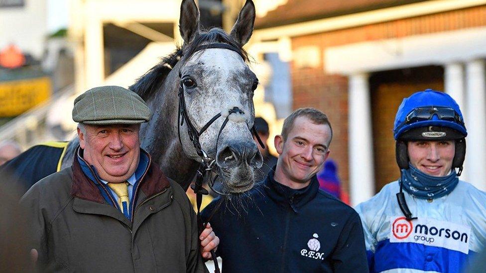 Kirkby (centre) pictured with trainer Paul Nicholls (left) and jockey Harry Cobden (right)