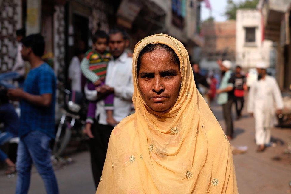 Mushtari Khatoon standing in a street