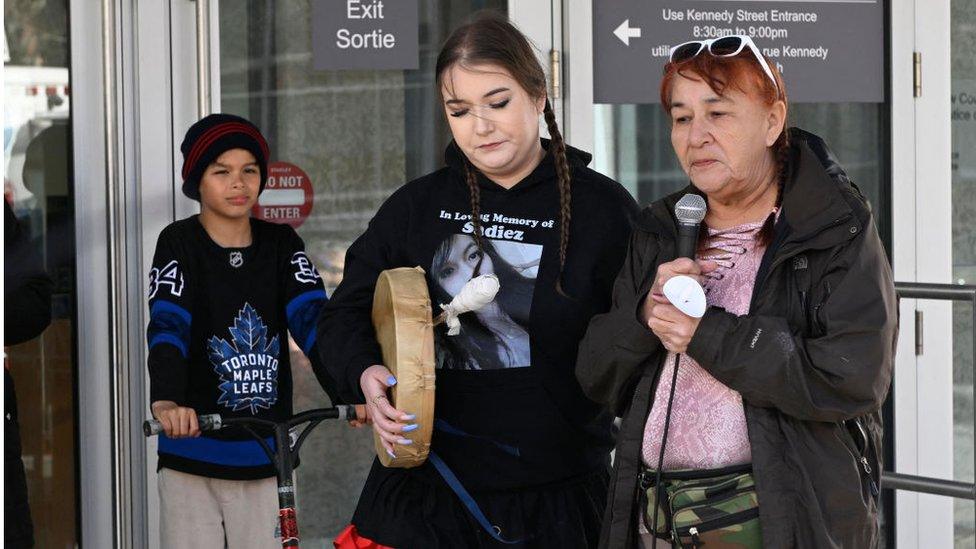 Jorden Myran (L) and Donna Bartlett (R), sister and grandmother of Marcedes Myran, speak during a candlelight vigil in front of Manitoba's highest trial court in Winnipeg, Manitoba