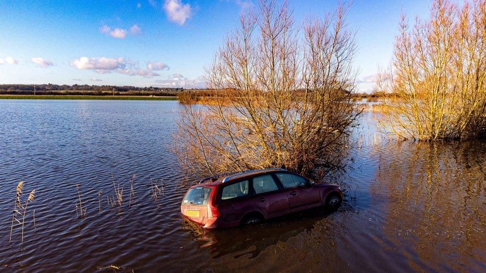 A car is stranded in floodwaters on Langport Road, near Muchelney, Somerset