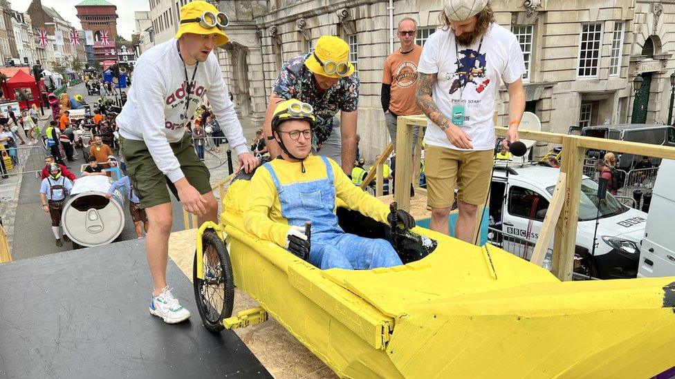 Kart decorated as a banana with the driver dressed as a yellow minion