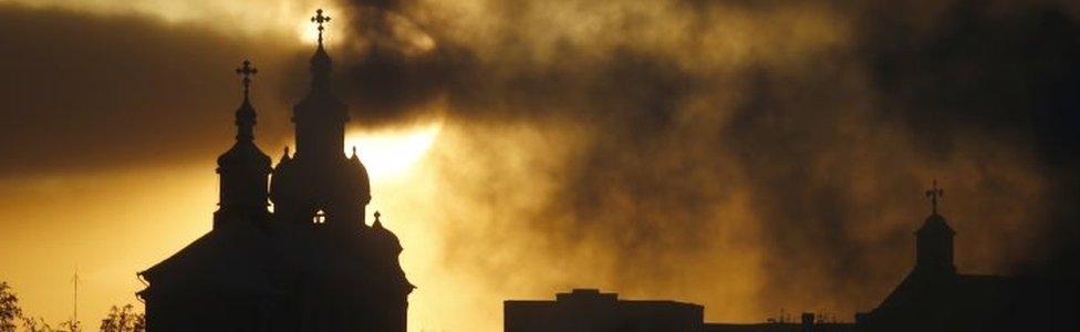 Sun rises above Orthodox Church (left) and Catholic Church (right) in Navahrudak, Belarus. Photo: January 2016