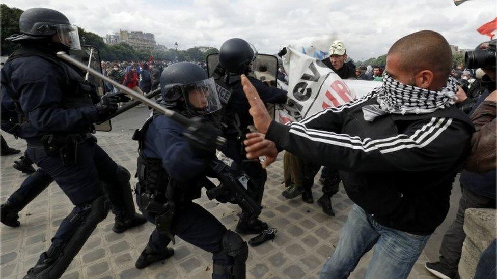 Masked youths and French police clash during a demonstration in Paris as part of nationwide protests against plans to reform French labour laws, France, June 14, 2016.