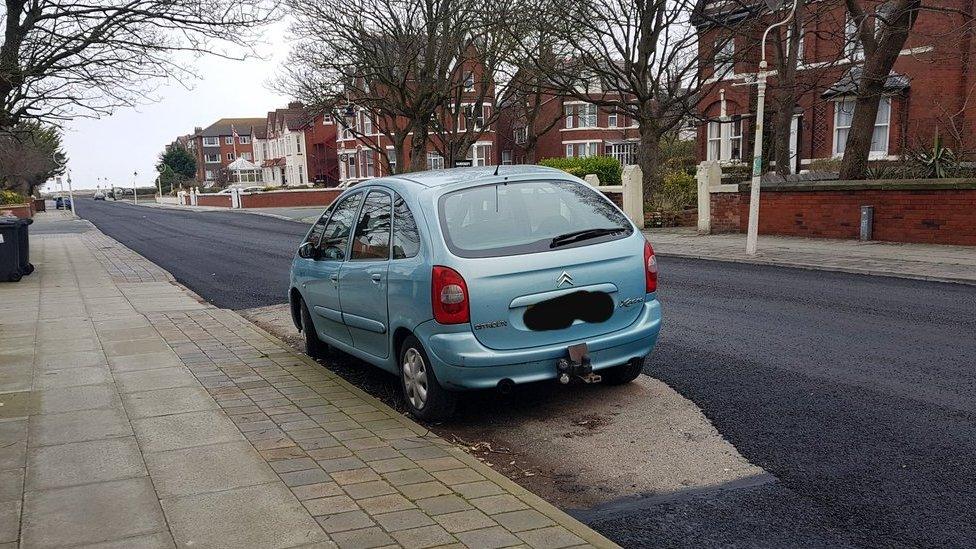 Car surrounded by road surface Southport